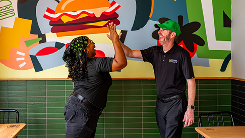 two team members high fiving